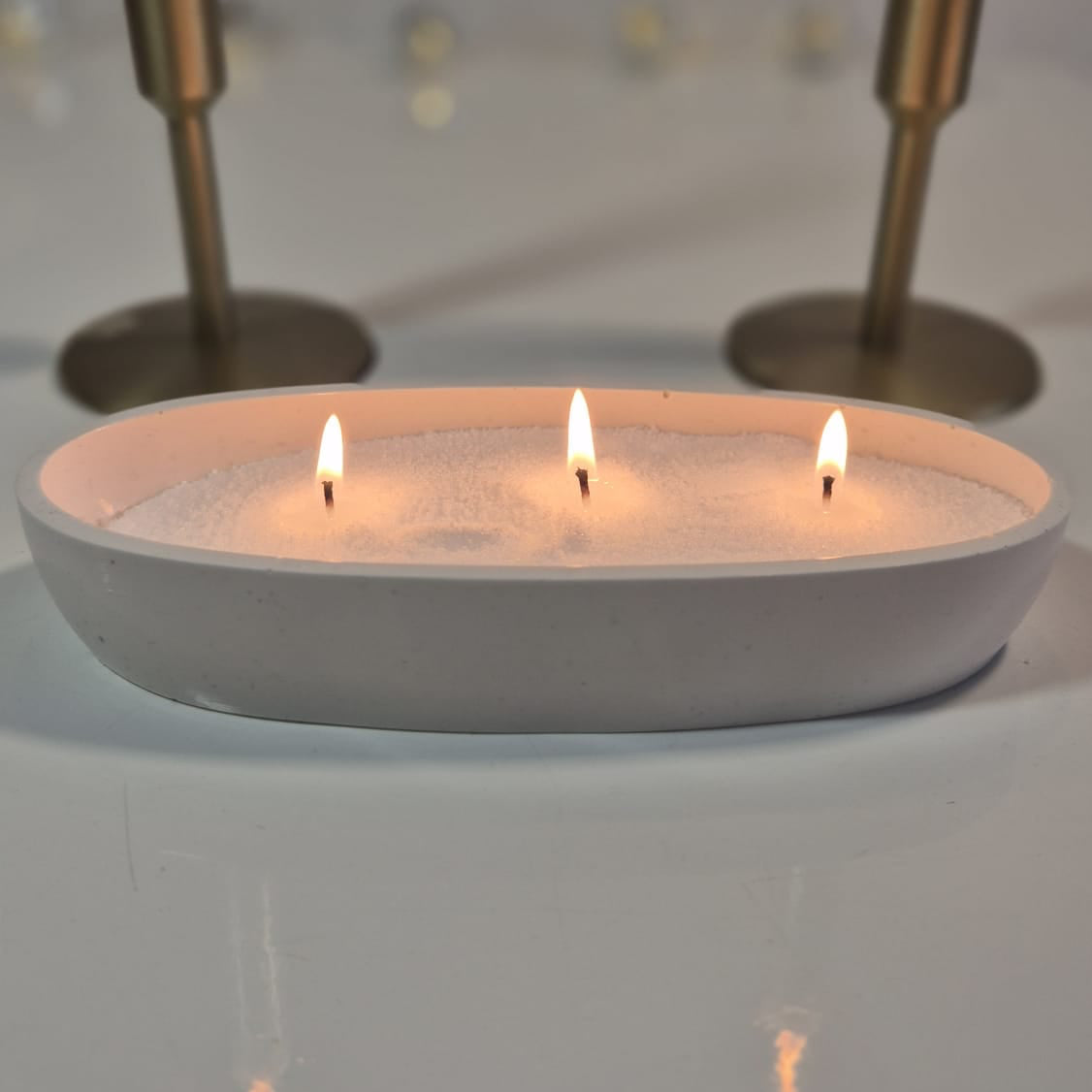 Sand wax candle in a white holder with wicks